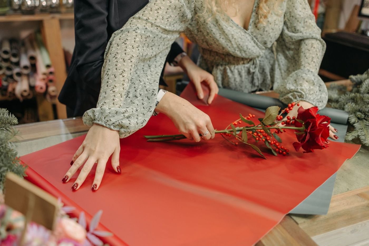 A florist hand-wrapping a custom flower gift