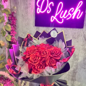 Dozen red satin roses bouquet in black and gold wrapping by DS Lush