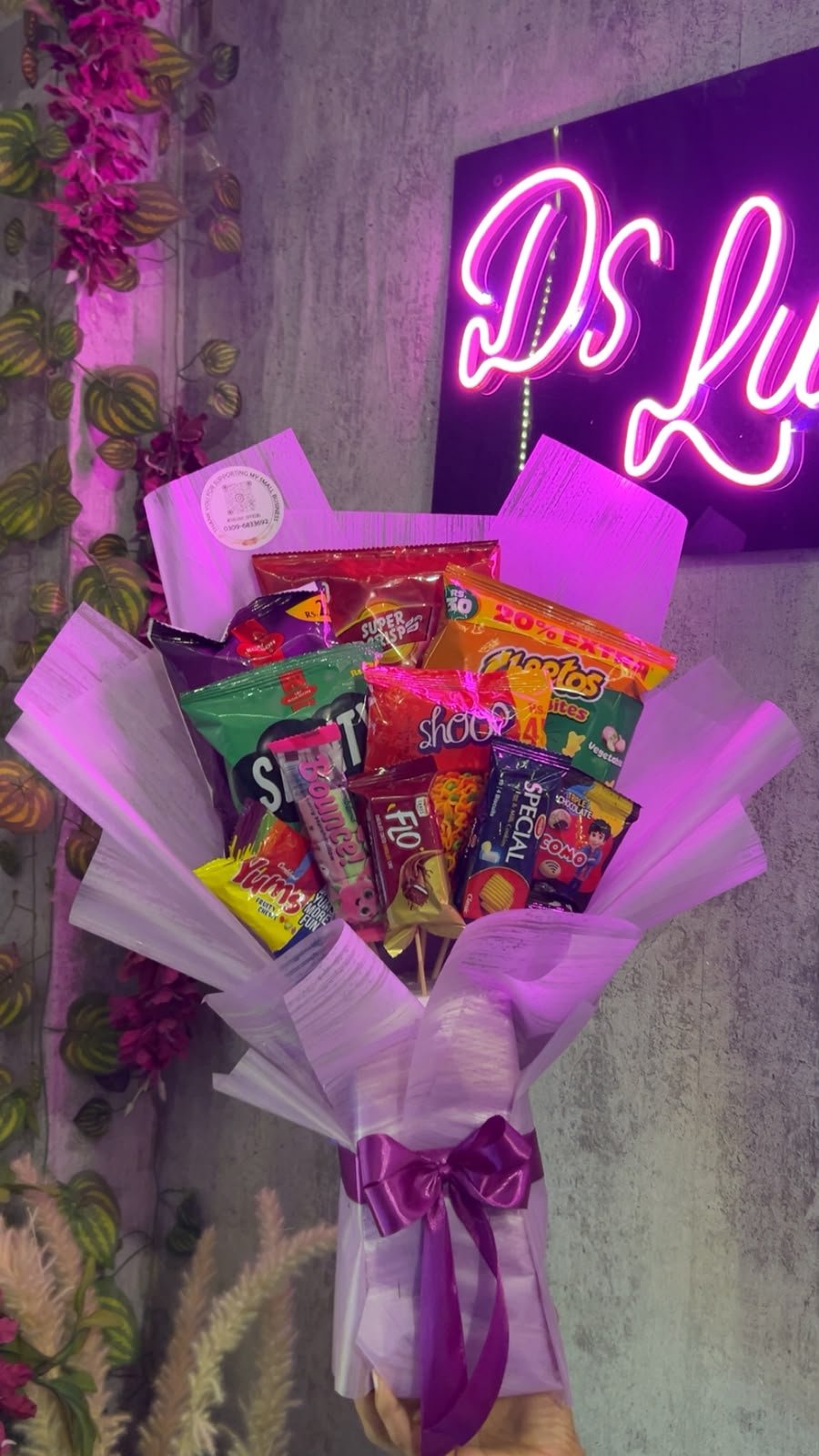 Assorted sweet and savoury snack packs in purple gift wrapping