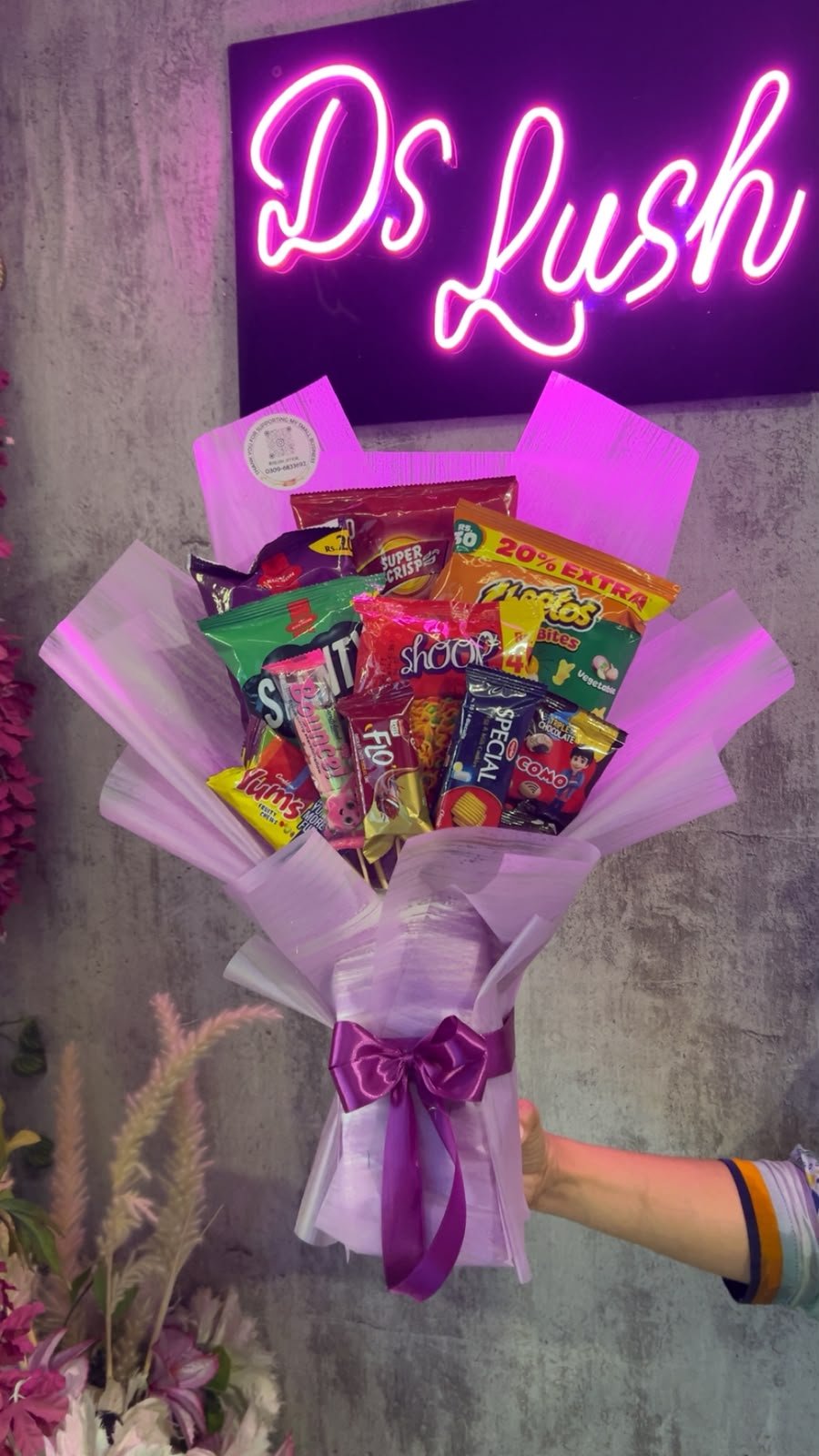 Lilac snack bouquet with assorted chips, biscuits and treats by DS Lush