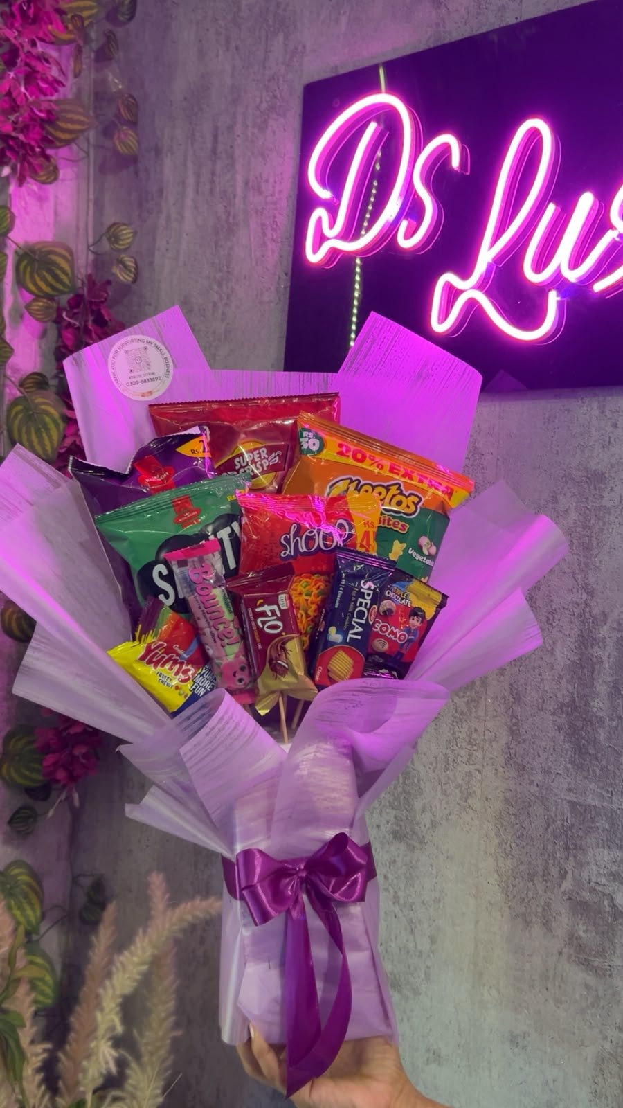 Full view of the lilac assorted snack surprise bouquet