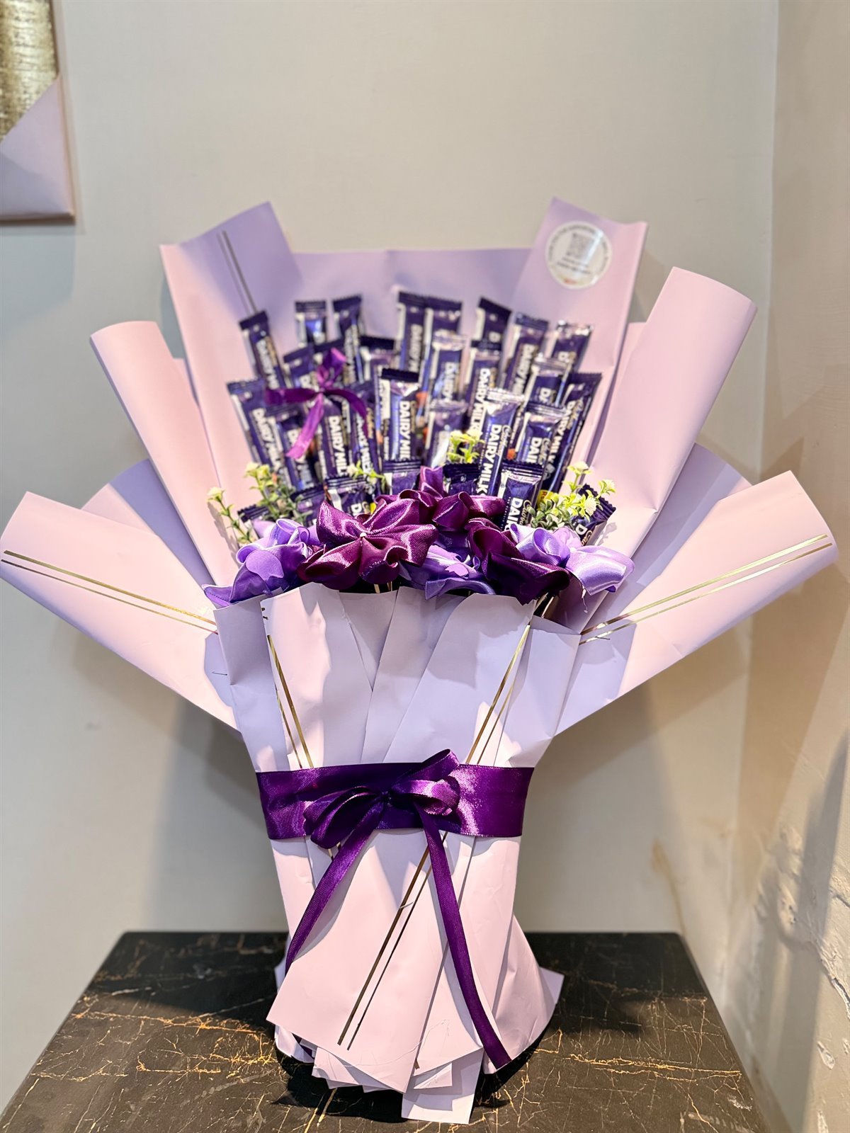 30 Cadbury chocolates with purple satin roses in a blush bouquet